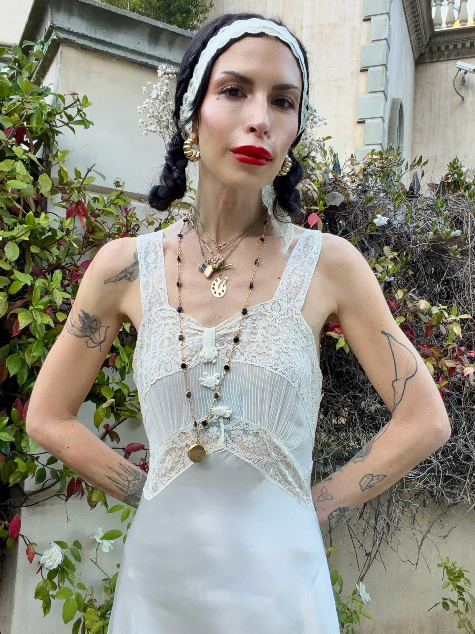 woman wearing antique 1930's silk slip gown in bone white with ivory lace and bias cut skirt