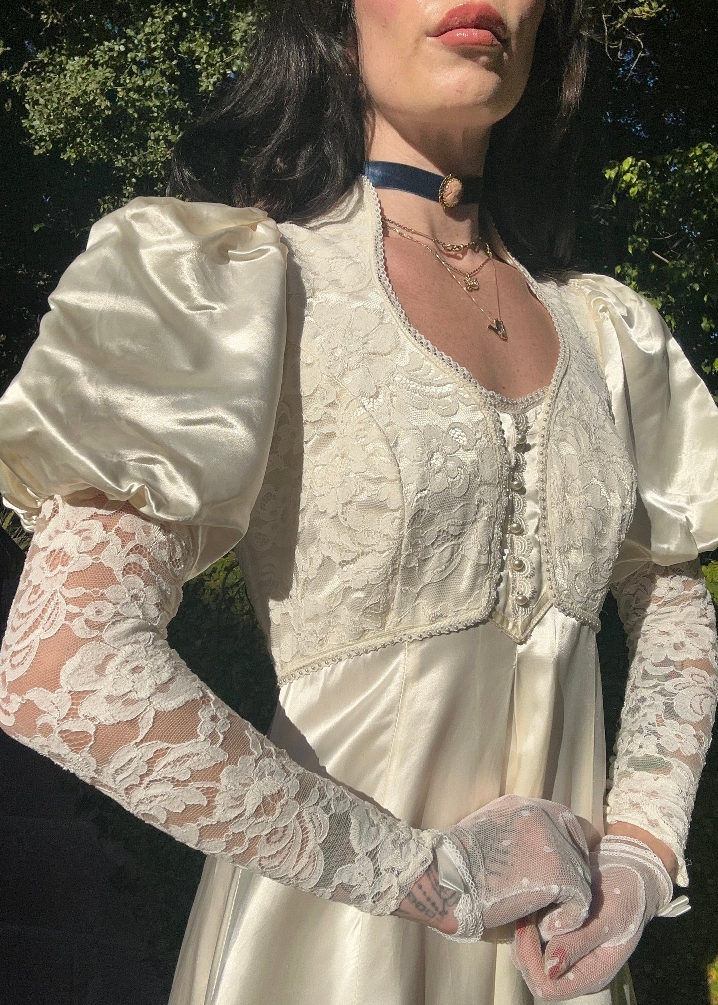 Person wearing a Gunne Sax dress with long sleeves and puff shoulders, standing outdoors.
