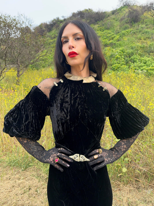 Woman wears antique 1930's black silk velvet Art Deco evening gown