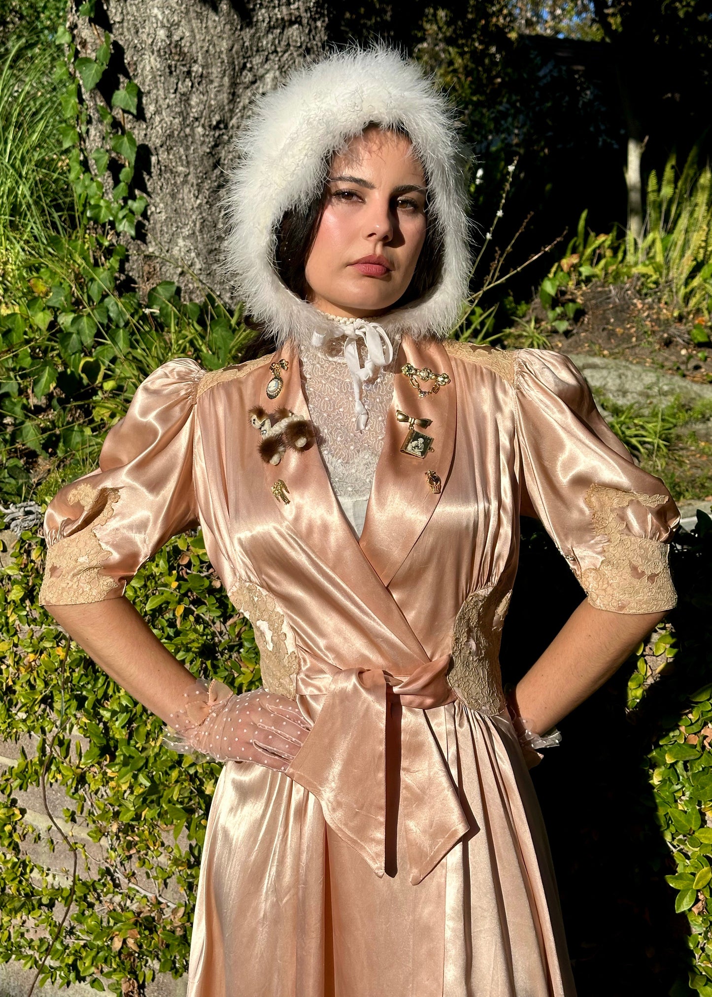 Person wearing a vintage-style dress with a fur hat in an outdoor setting