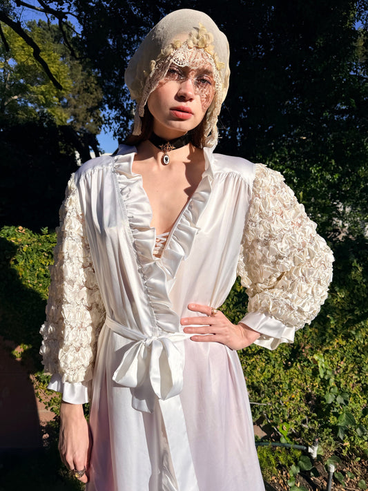 Person wearing a white dress with floral details outdoors