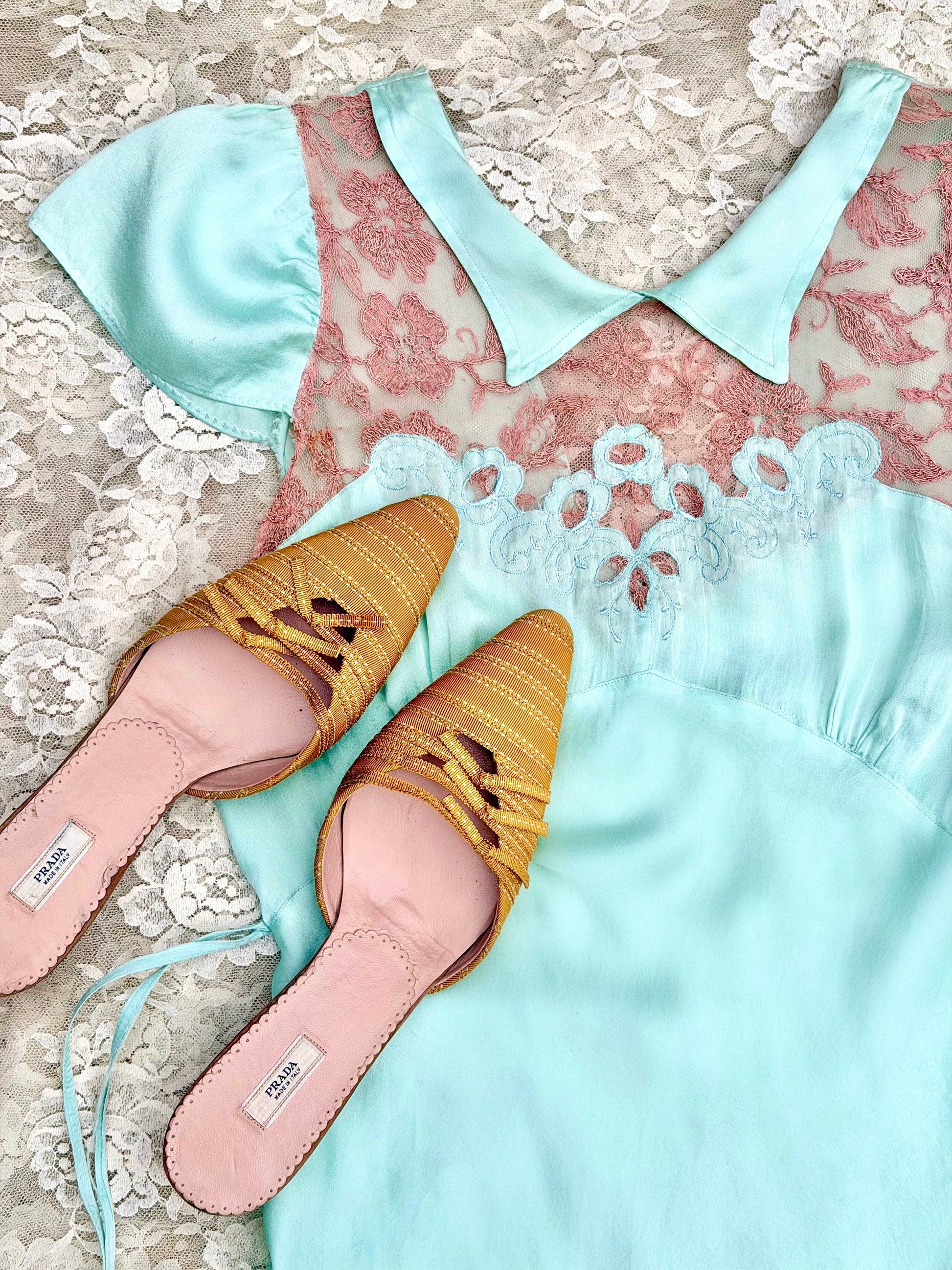 Pair of vintage prada yellow woven shoes with pink soles on a lace background