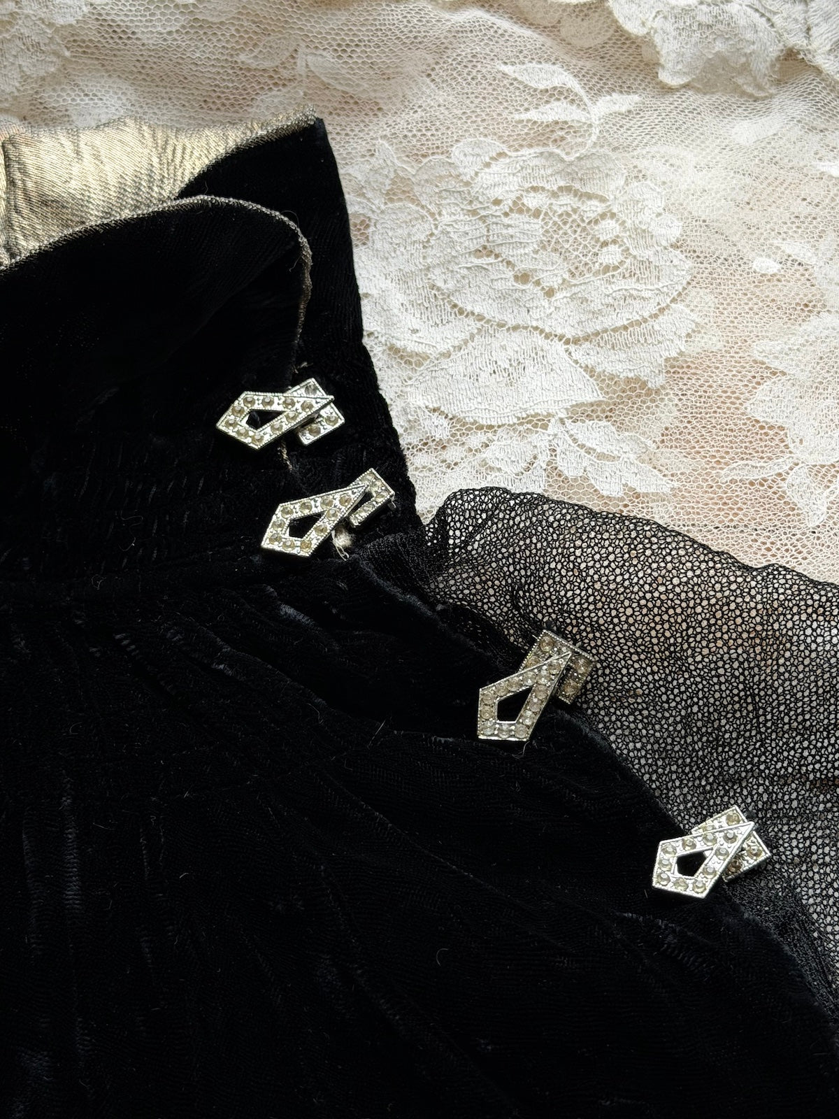 Woman wears antique 1930's black silk velvet Art Deco evening gown in field