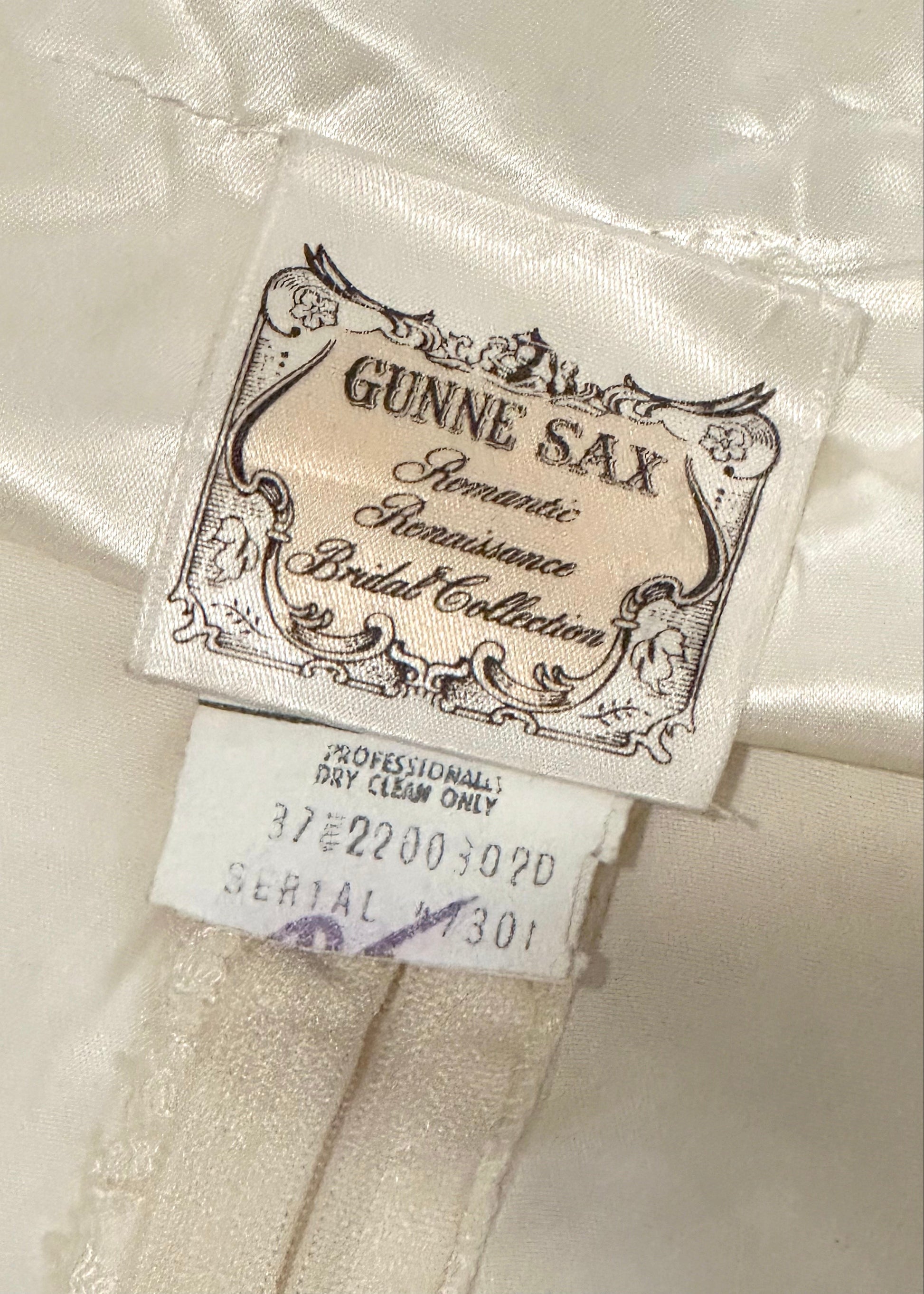 Gunne Sax label on a bridal gown with decorative text and design.